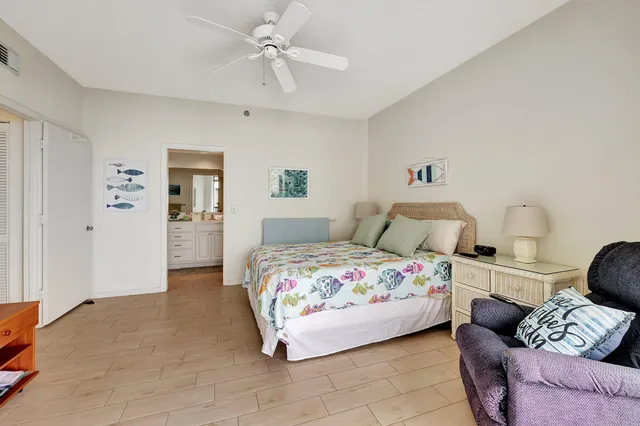 a front view of a multi story residential apartment building with yard and green space