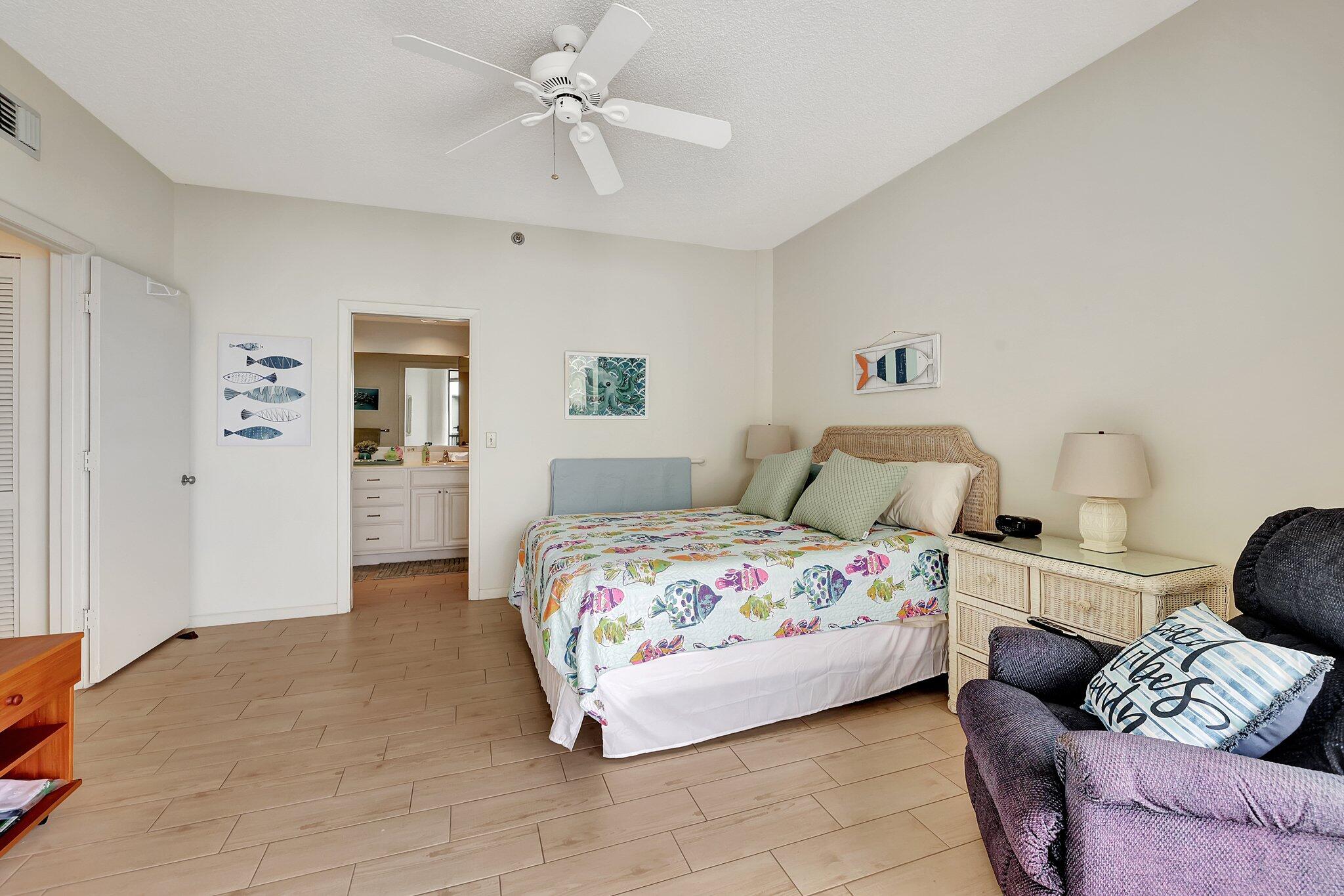 221 Northeast Plantation Road, Unit 406 Stuart, FL 34996 - Photo 33 of 58 a bedroom with bed and window