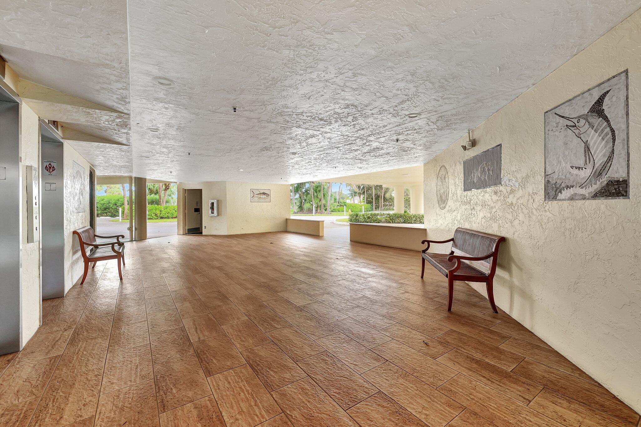 221 Northeast Plantation Road, Unit 406 Stuart, FL 34996 - Photo 37 of 58 a living room with furniture and a wooden floor