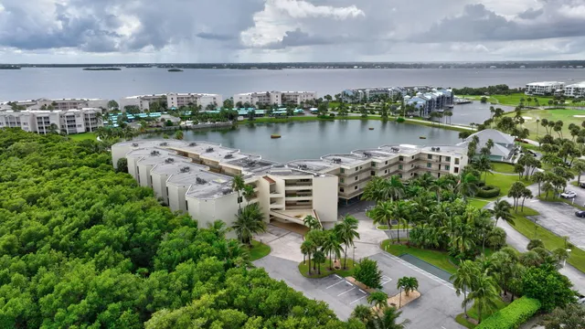 a view of a lake with lawn chairs