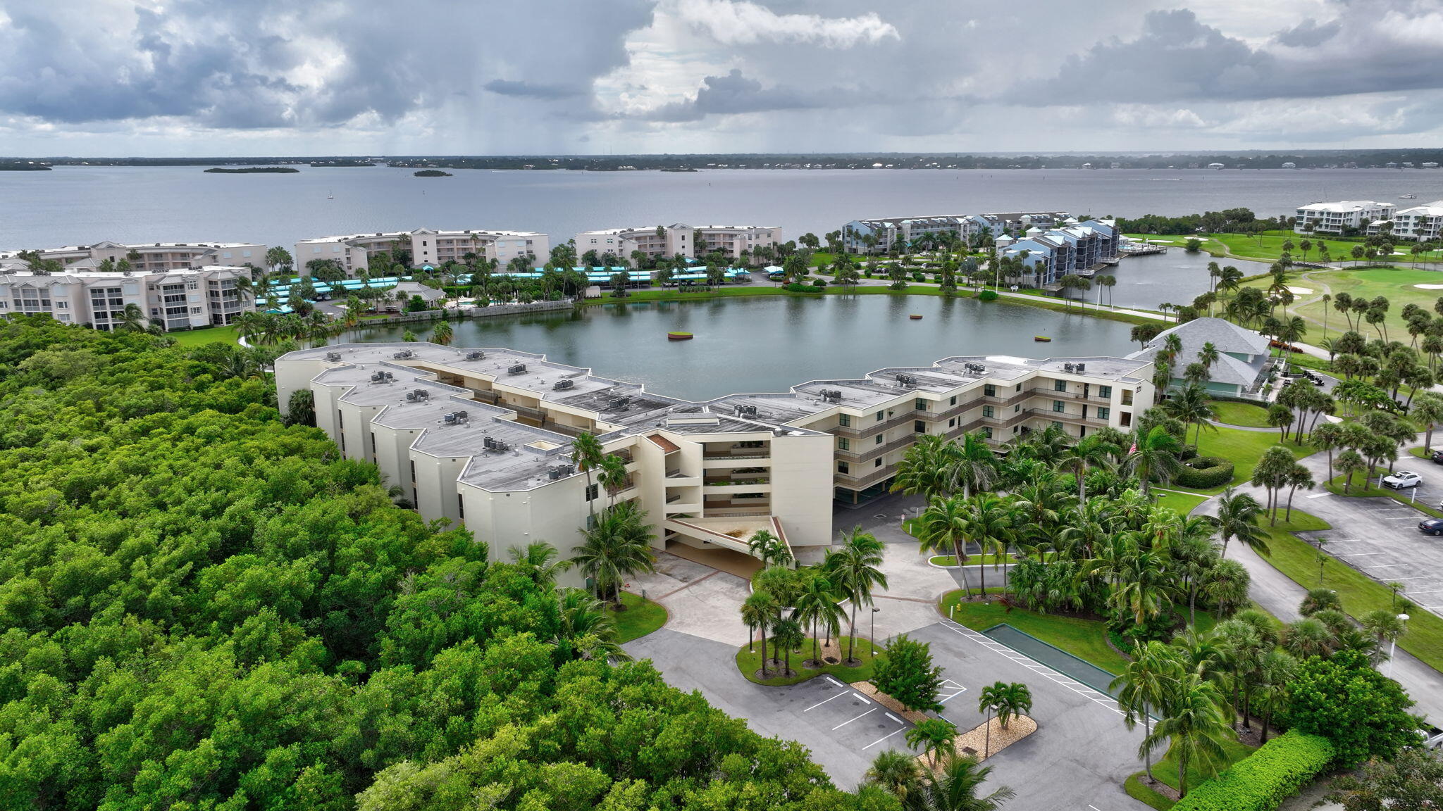 221 Northeast Plantation Road, Unit 406 Stuart, FL 34996 - Photo 42 of 58 an aerial view of a house with a yard and lake view