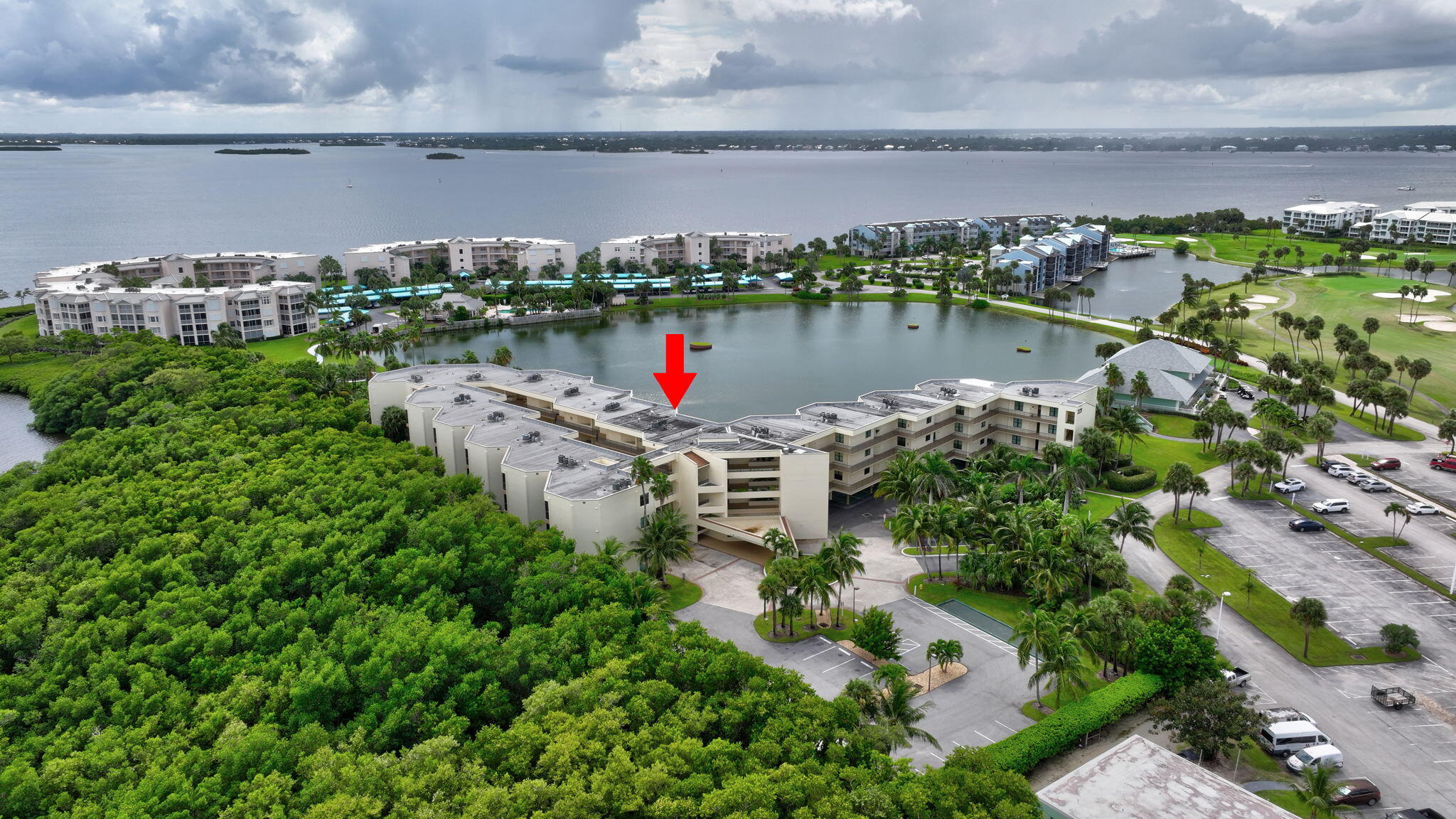 221 Northeast Plantation Road, Unit 406 Stuart, FL 34996 - Photo 43 of 58 an aerial view of a house with a yard and lake view