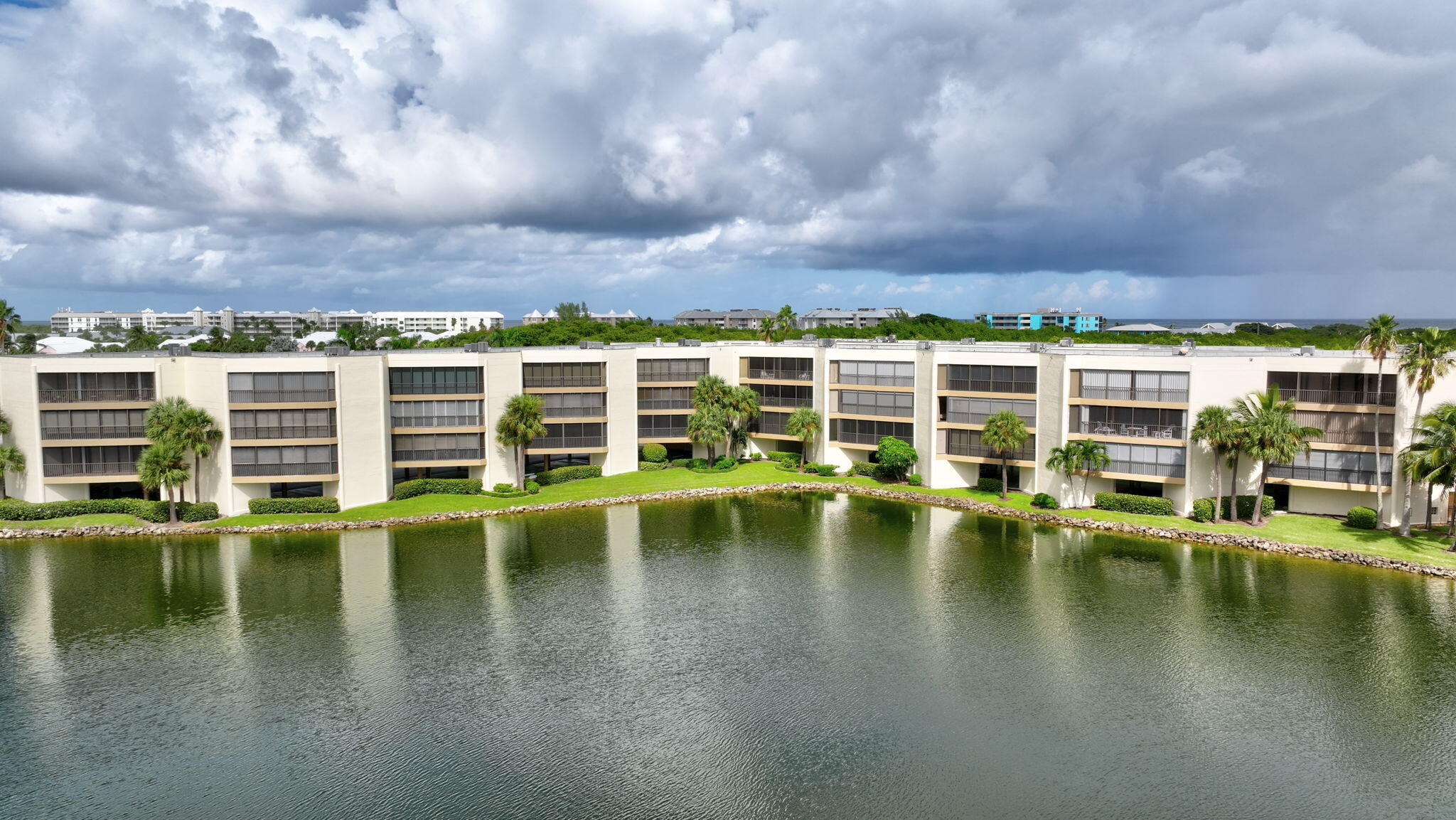 221 Northeast Plantation Road, Unit 406 Stuart, FL 34996 - Photo 53 of 58 a view of a swimming pool and lounge chair