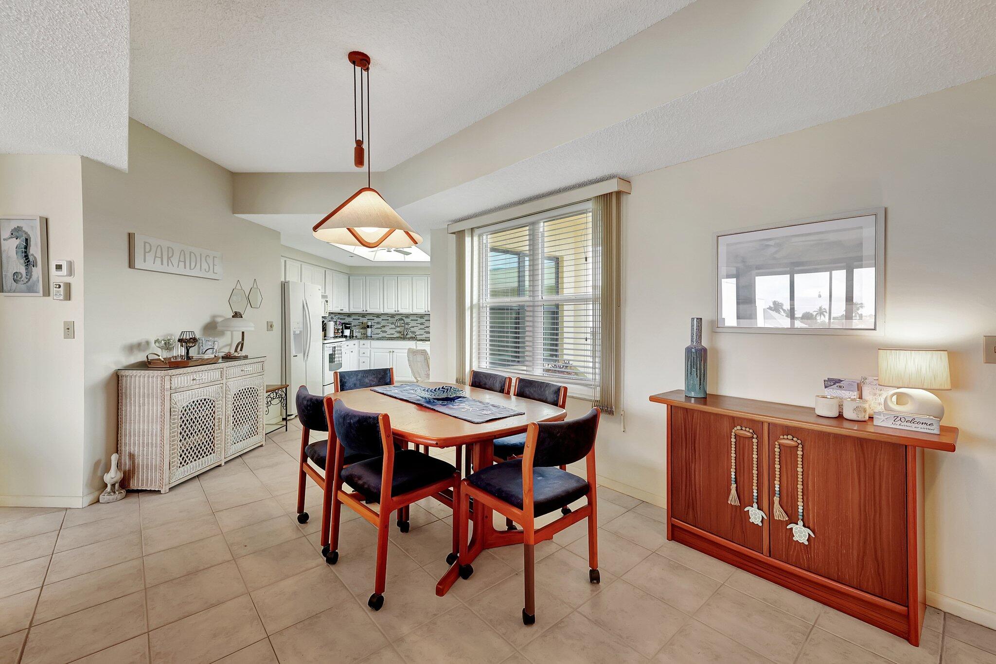 221 Northeast Plantation Road, Unit 406 Stuart, FL 34996 - Photo 7 of 58 a view of a dining room and livingroom with furniture wooden floor a chandelier