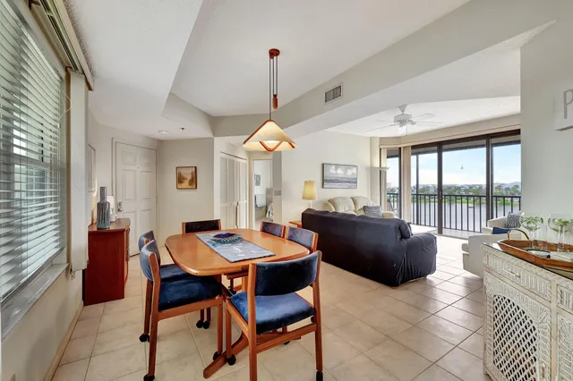 a kitchen with stainless steel appliances a stove a sink and white cabinets