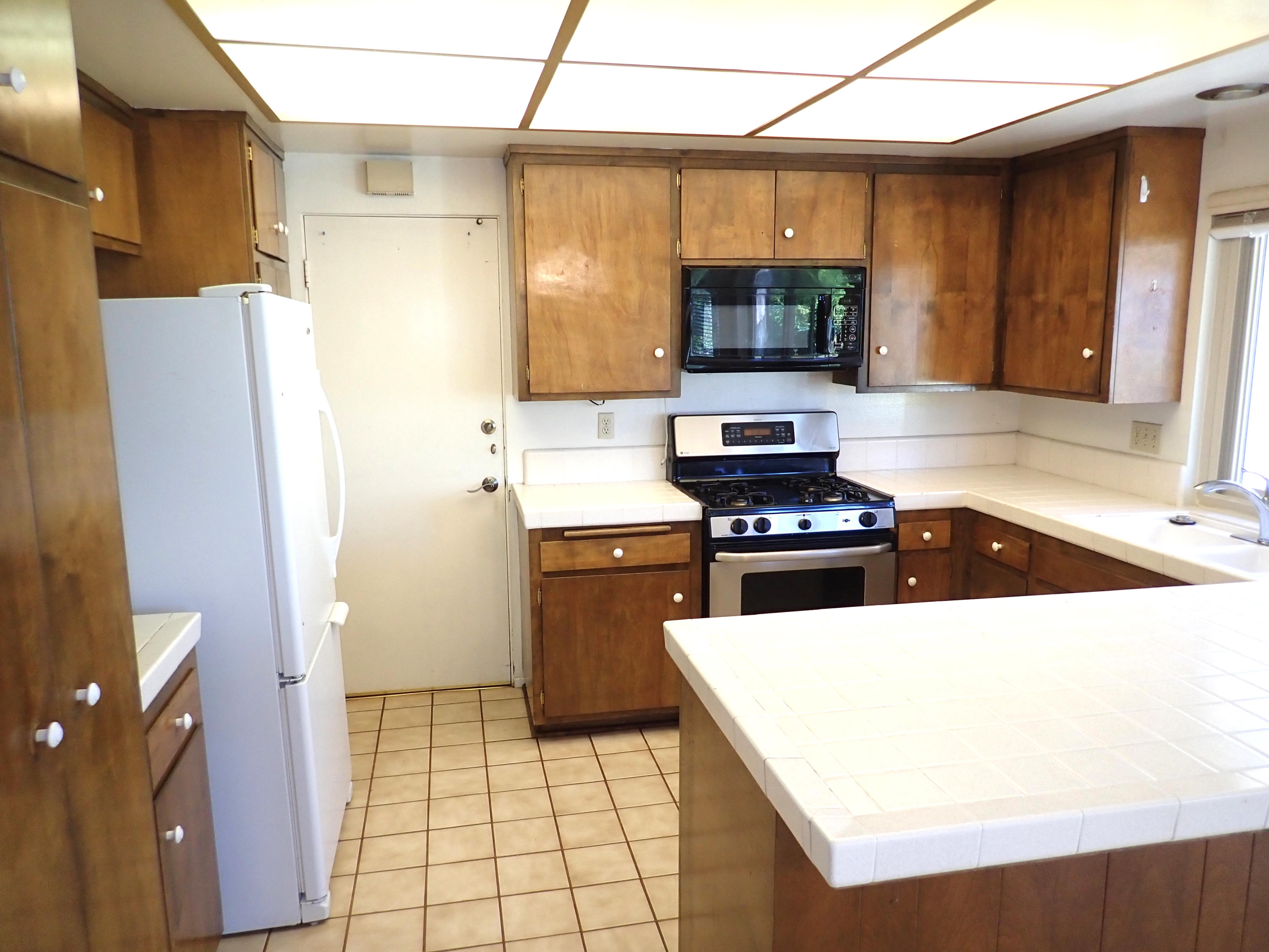 483 Reed Court Goleta, CA 93117 - Photo 11 of 37 a kitchen with a sink a stove and a refrigerator