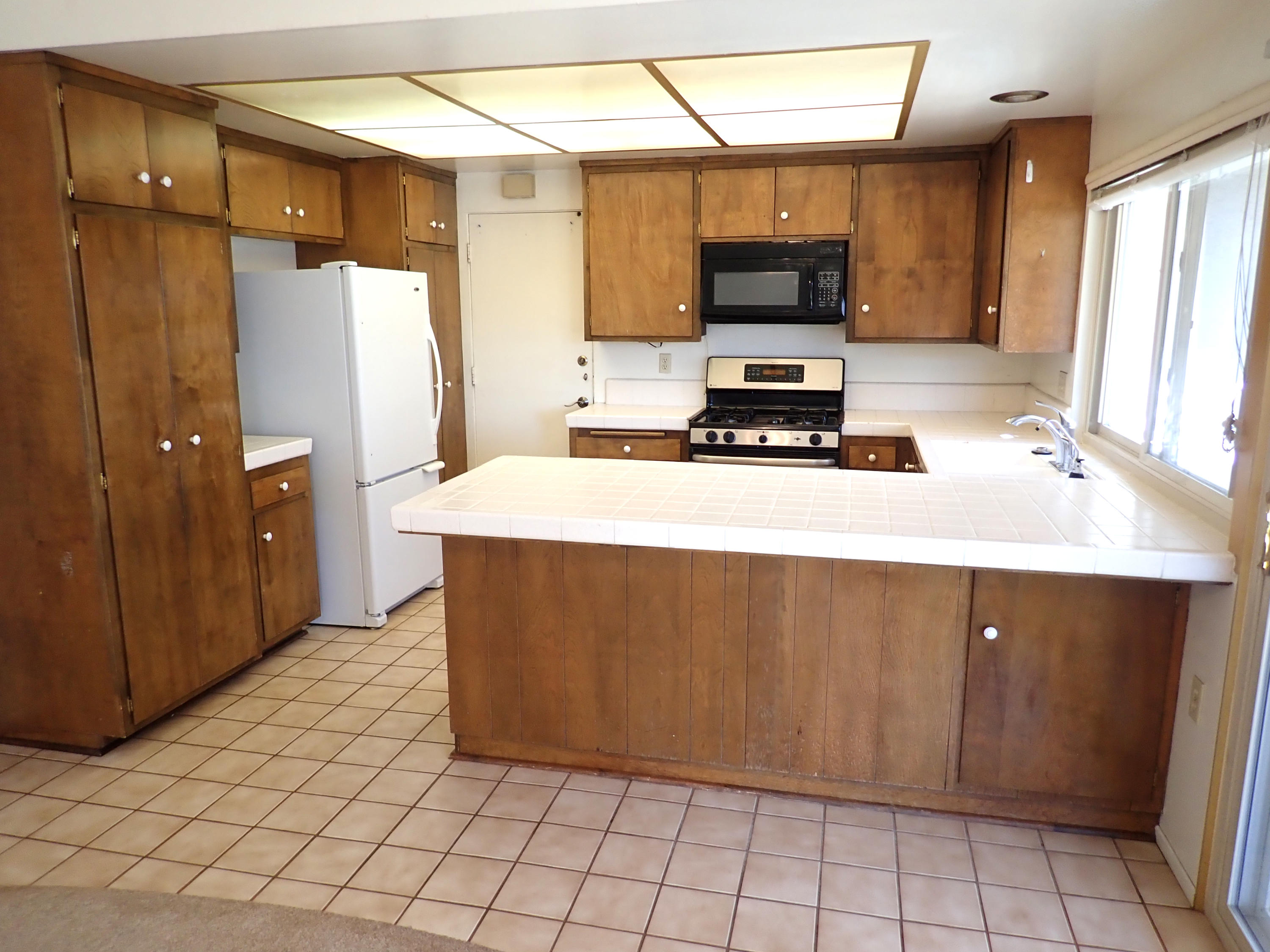 483 Reed Court Goleta, CA 93117 - Photo 10 of 37 a kitchen with a sink and a refrigerator