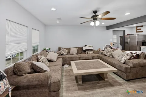 a living room with furniture and a chandelier