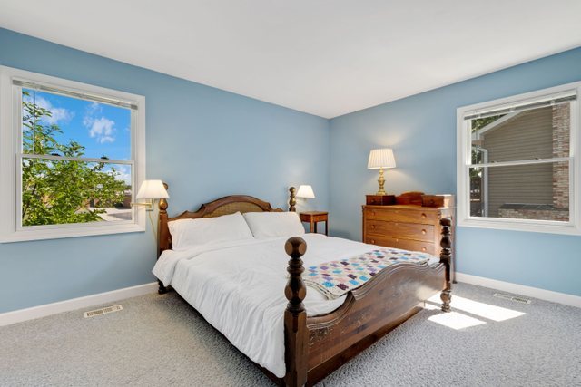 Undisclosed Address Buffalo Grove, IL 60089 - Photo 12 of 30 a bed sitting in a bedroom next to a window