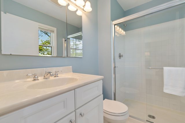 Undisclosed Address Buffalo Grove, IL 60089 - Photo 14 of 30 a bathroom with a sink a toilet a window and shower