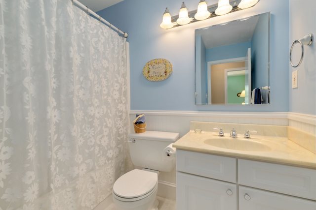 Undisclosed Address Buffalo Grove, IL 60089 - Photo 15 of 30 a bathroom with a sink a toilet and a mirror