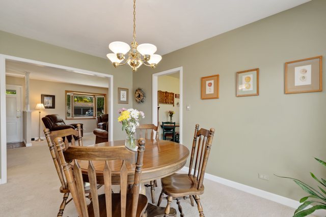 Undisclosed Address Buffalo Grove, IL 60089 - Photo 18 of 30 a view of a dining room with furniture and chandelier