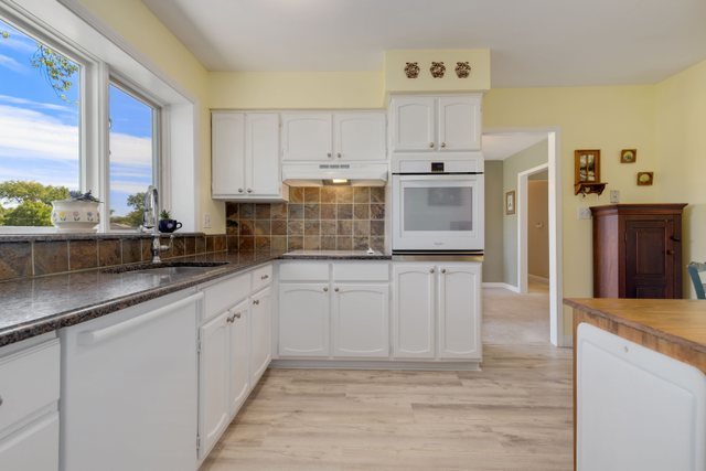 Undisclosed Address Buffalo Grove, IL 60089 - Photo 20 of 30 a kitchen with granite countertop white cabinets and stainless steel appliances