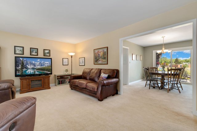 Undisclosed Address Buffalo Grove, IL 60089 - Photo 7 of 30 a living room with furniture and a flat screen tv