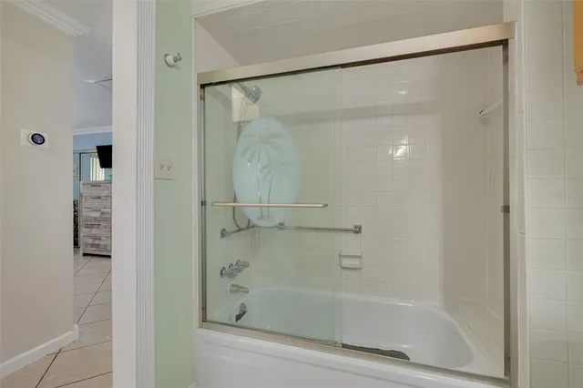 a bathroom with a glass shower door