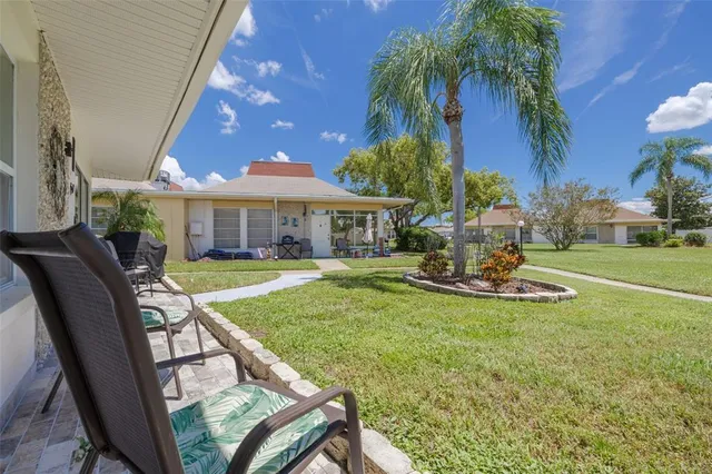 a view of a house with swimming pool and sitting area