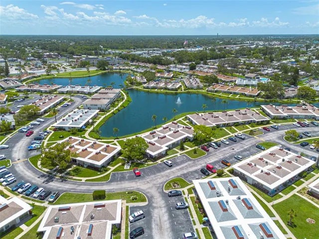 an aerial view of residential building and lake