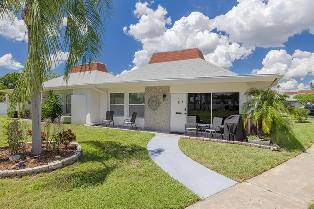 a view of a house with backyard porch and sitting area