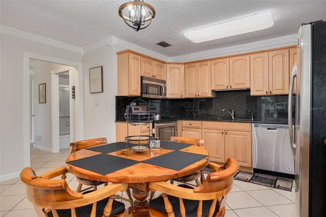 a kitchen with a dining table and chairs