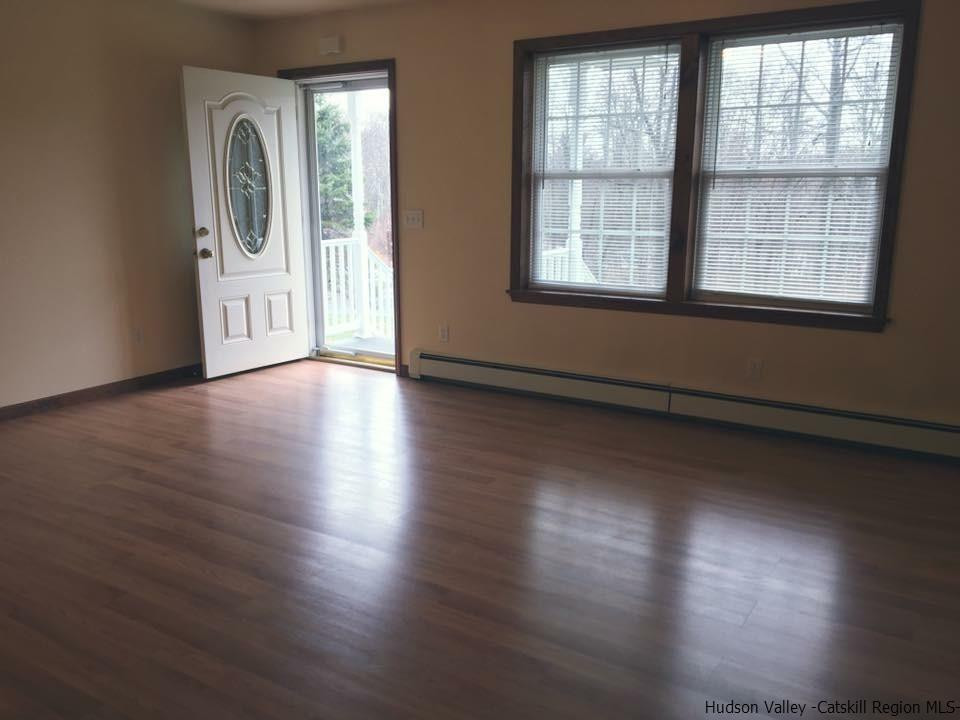 369 New Unionville Road, Unit 1 Wallkill, NY 12589 - Photo 3 of 11 an empty room with wooden floor and windows