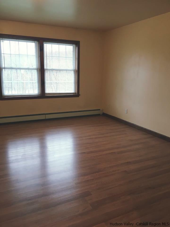 369 New Unionville Road, Unit 1 Wallkill, NY 12589 - Photo 4 of 11 an empty room with wooden floor and windows