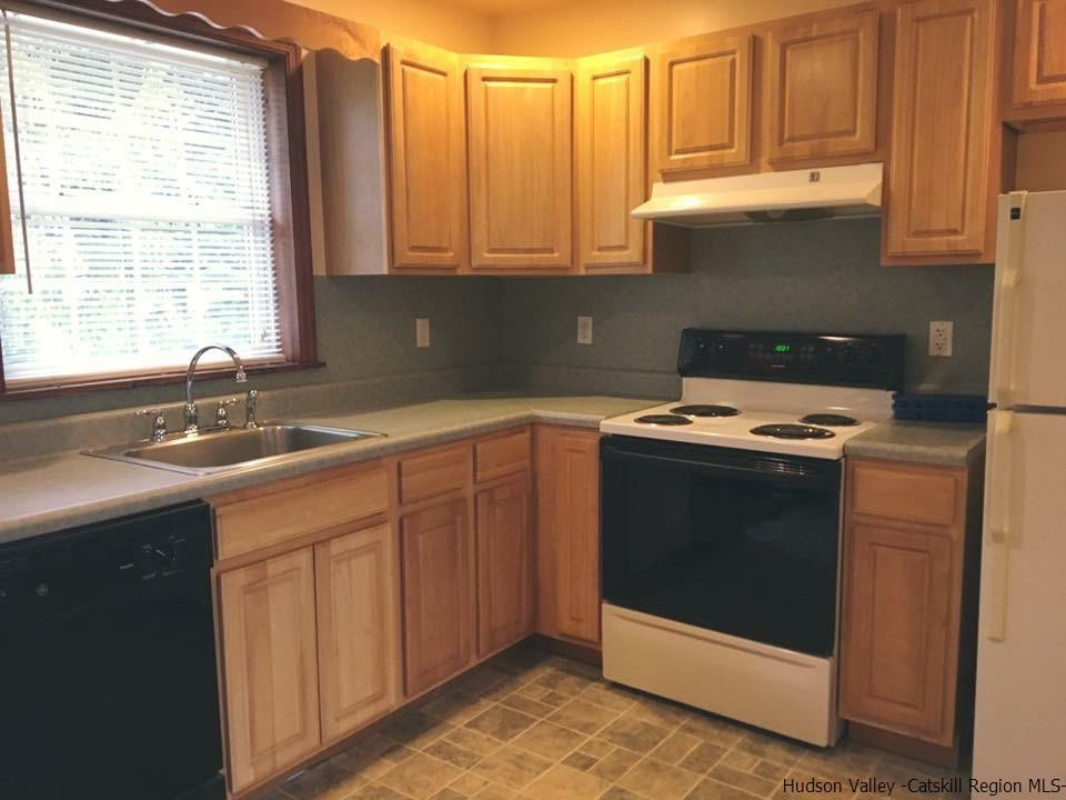 369 New Unionville Road, Unit 1 Wallkill, NY 12589 - Photo 6 of 11 a kitchen with stainless steel appliances granite countertop white cabinets sink and window