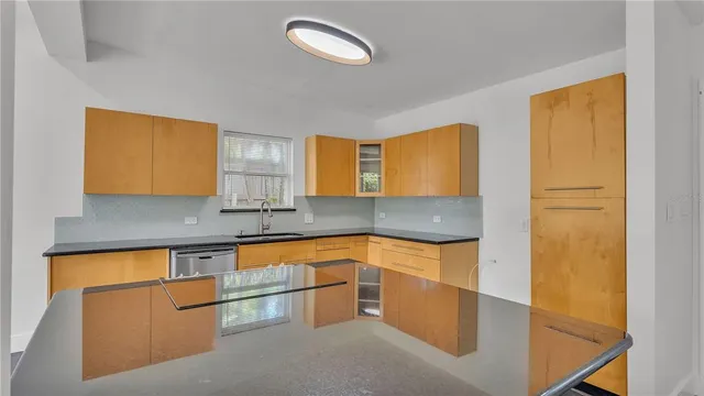a kitchen with granite countertop a stove and a sink