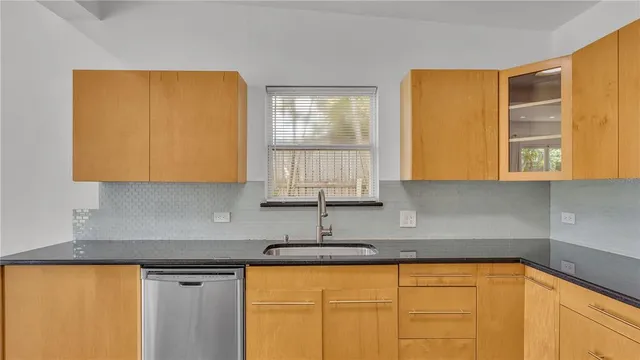 a kitchen with granite countertop a stove and a refrigerator