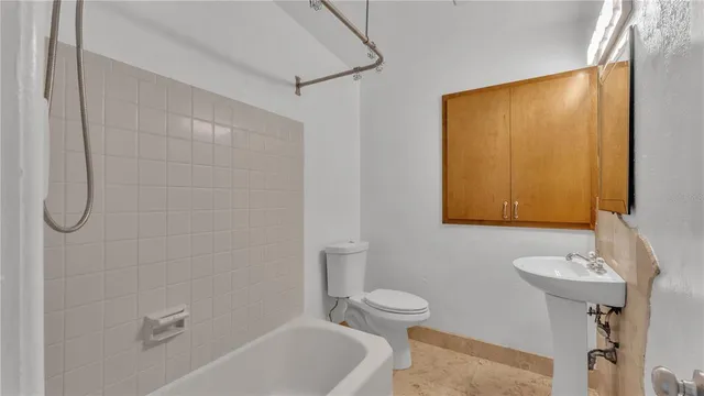 a white toilet sitting next to a bathroom sink