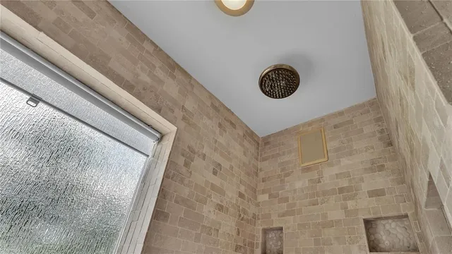 a yellow house with a large tree and yard in front of it