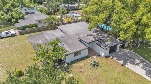 an aerial view of a house with a yard