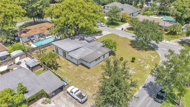 an aerial view of a house with a yard