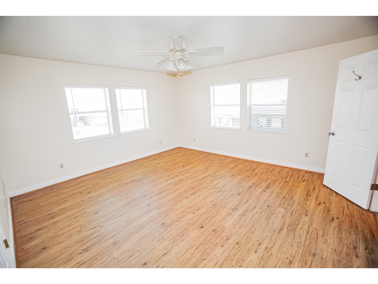 419 Thunder Road Surfside Beach, TX 77541 - Photo 21 of 32 This spacious, bright room features hardwood flooring, neutral walls, and ample natural light from multiple windows. A ceiling fan adds comfort and the open layout offers versatility for your decor.