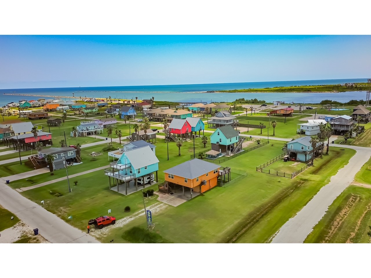 419 Thunder Road Surfside Beach, TX 77541 - Photo 27 of 32 This coastal neighborhood features vibrant, elevated homes with spacious yards, offering stunning ocean views and proximity to the water. Perfect for beach lovers seeking a colorful and serene community setting.