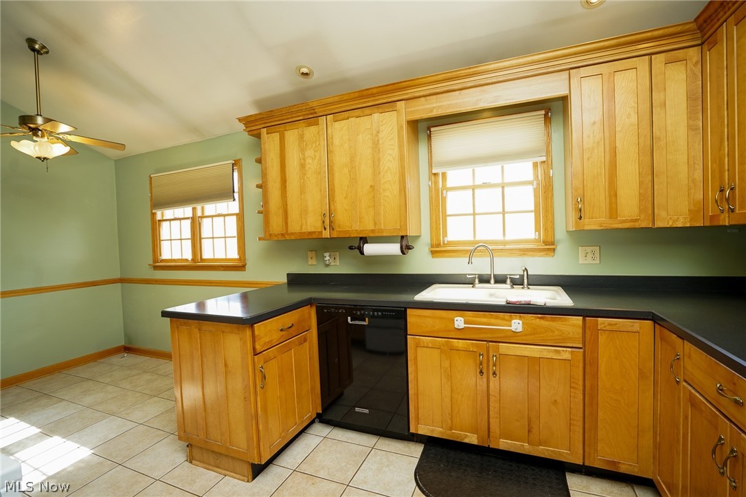 453 Omar Street Struthers, OH 44471 - Photo 17 of 27 Kitchen featuring a peninsula, black dishwasher, dark countertops, and a ceiling fan