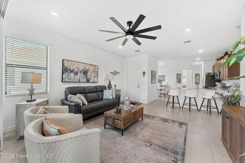 a kitchen with stainless steel appliances kitchen island granite countertop a refrigerator and cabinets