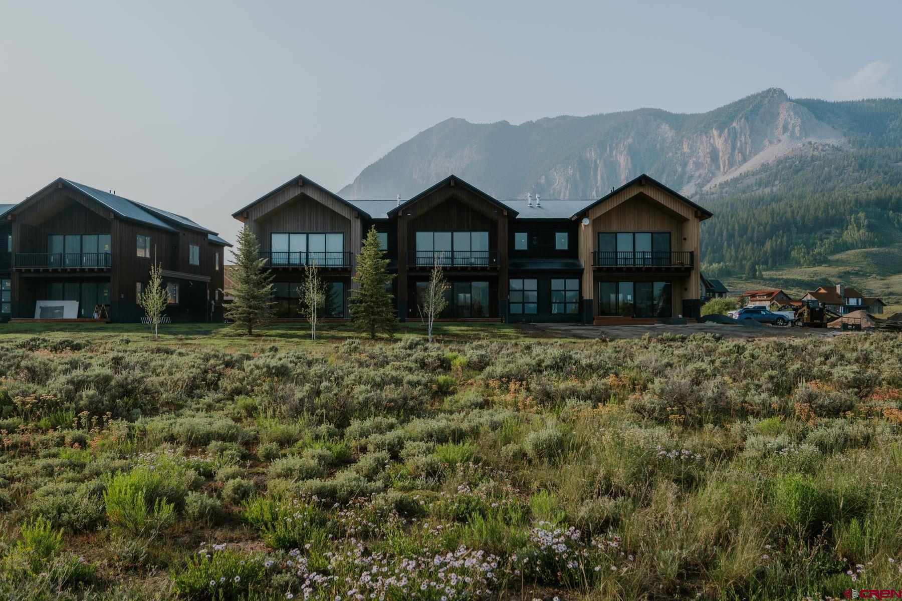 180 Elk Valley Road, Unit 105 Crested Butte, CO 81224 - Photo 1 of 35 a front view of a house with a yard
