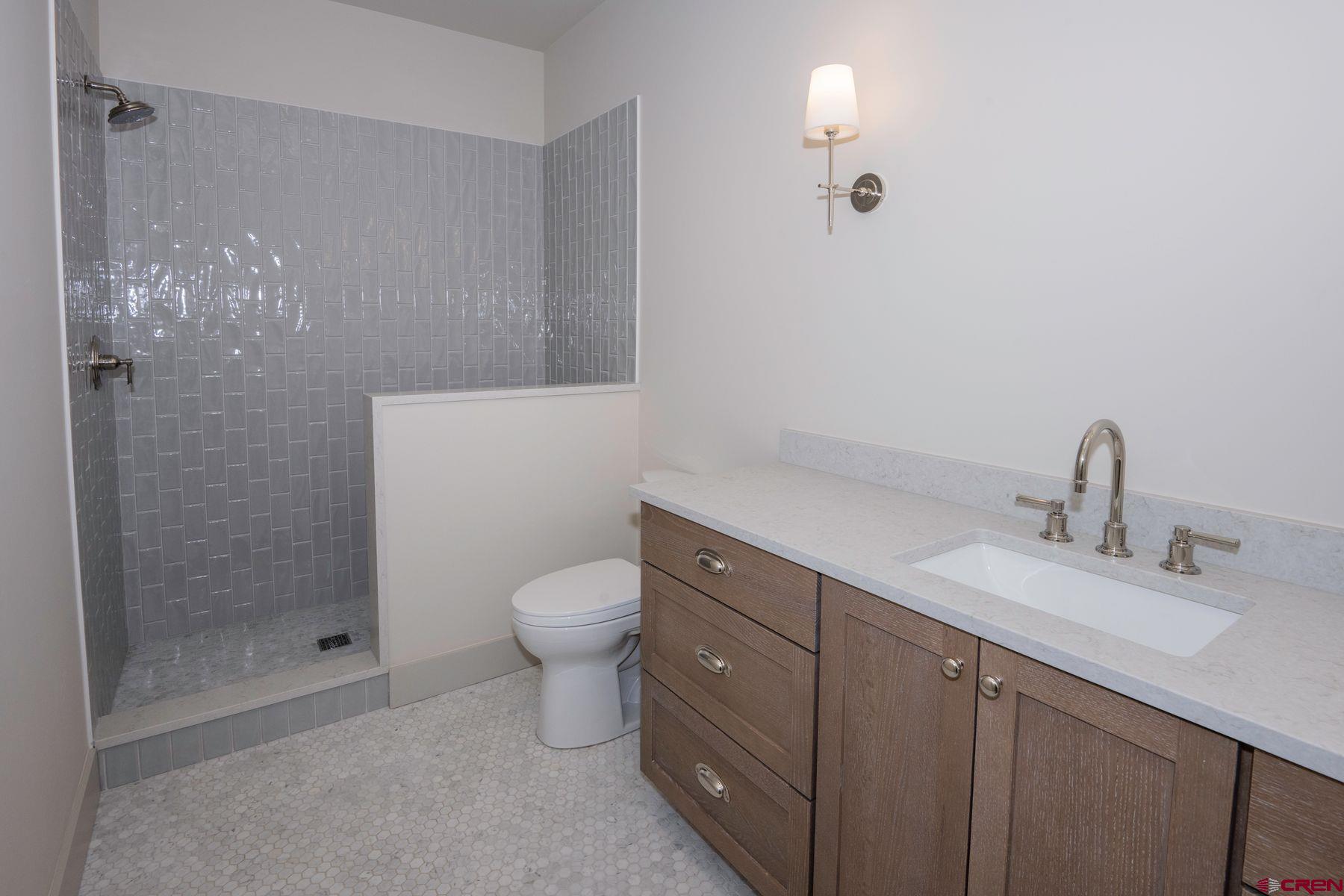 180 Elk Valley Road, Unit 105 Crested Butte, CO 81224 - Photo 18 of 35 a bathroom with a toilet sink and shower