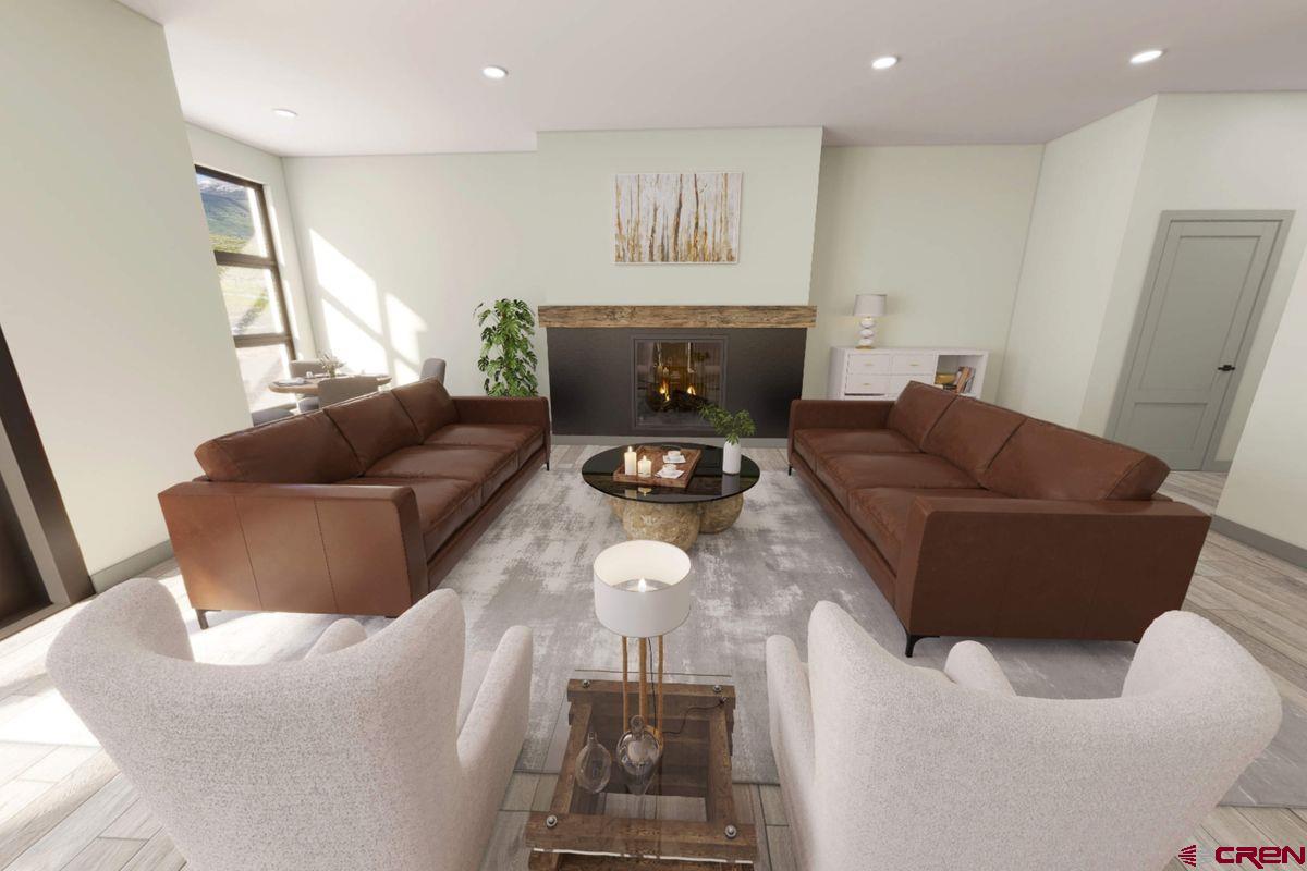 180 Elk Valley Road, Unit 105 Crested Butte, CO 81224 - Photo 27 of 35 a living room with furniture and a fireplace