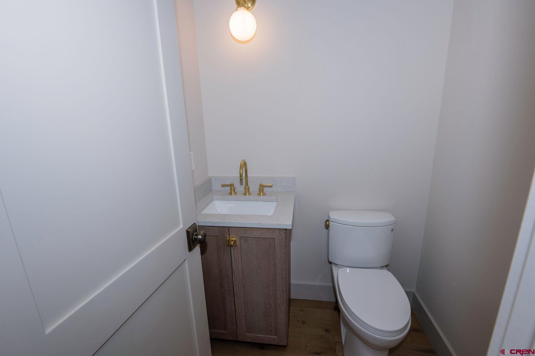 180 Elk Valley Road, Unit 105 Crested Butte, CO 81224 - Photo 9 of 35 a bathroom with a toilet a sink and mirror