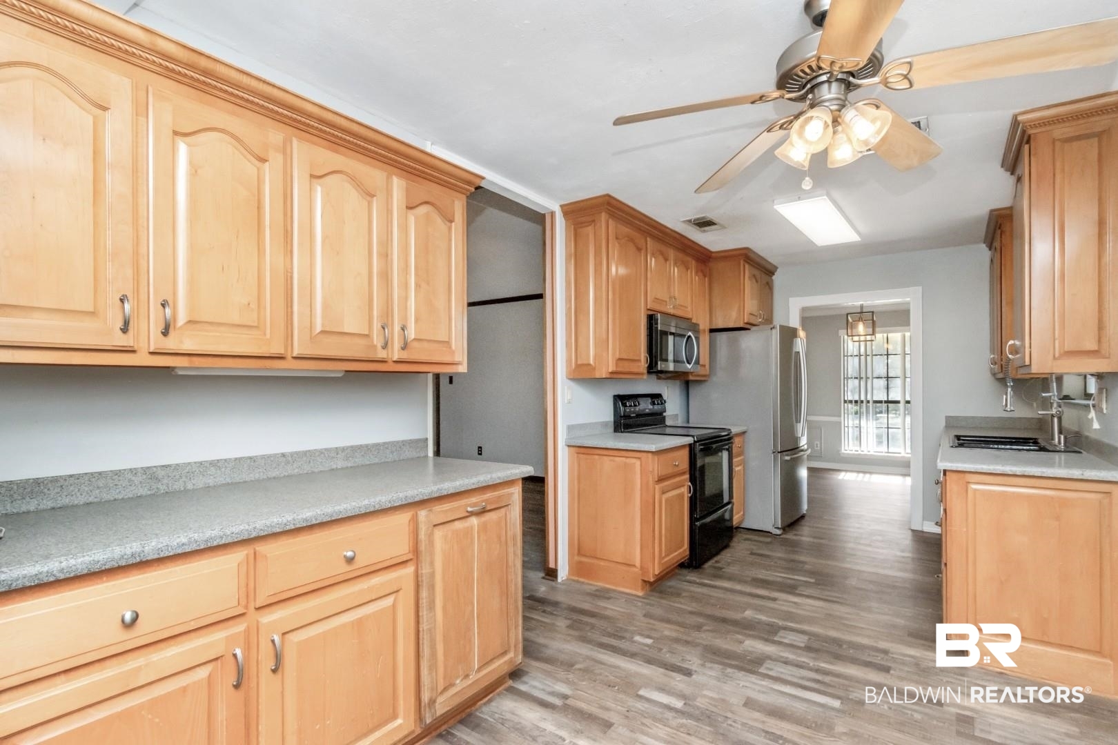 8304 Champlain Circle Mobile, AL 36695 - Photo 15 of 46 Kitchen with sink, light hardwood / wood-style floors, ceiling fan, and appliances with stainless steel finishes