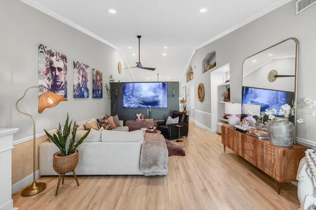 a living room with furniture and a wooden floor