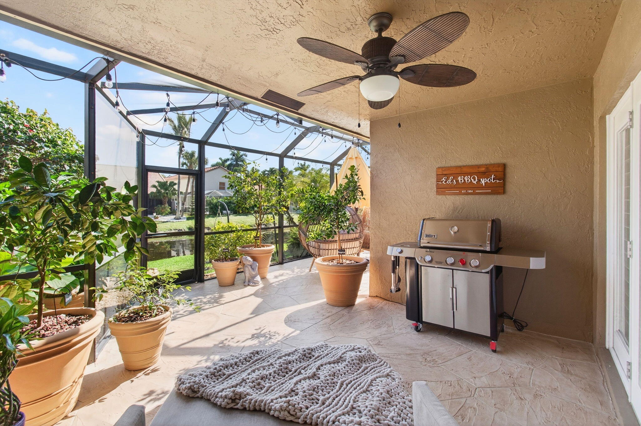 21400 Millbrook Court Boca Raton, FL 33498 - Photo 49 of 65 a living room with blue lights with furniture and a potted plant