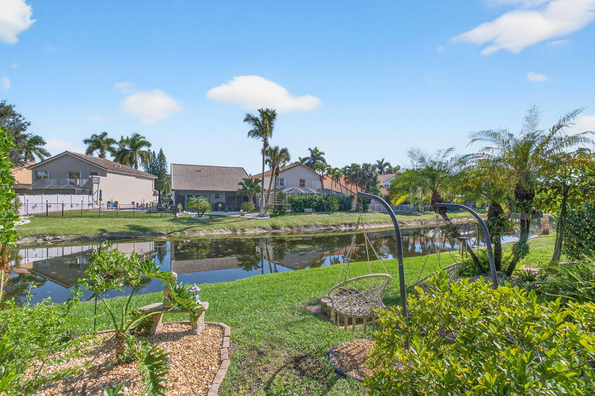 21400 Millbrook Court Boca Raton, FL 33498 - Photo 55 of 65 a view of a lake with a house in the background
