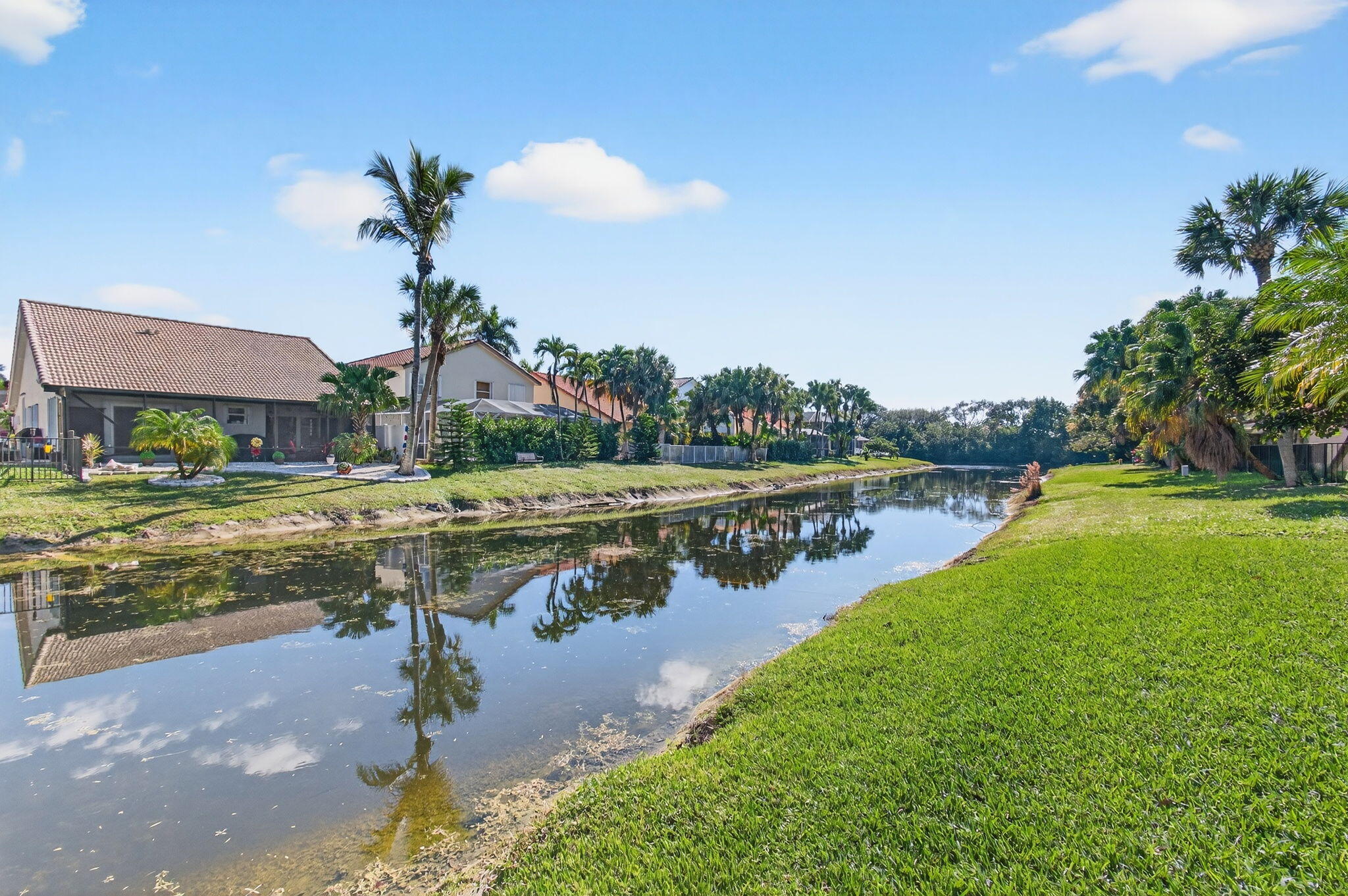 21400 Millbrook Court Boca Raton, FL 33498 - Photo 56 of 65 a view of a lake with a yard and a large tree