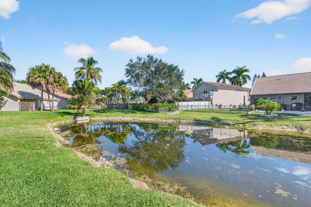 a view of swimming pool with a garden and lake view