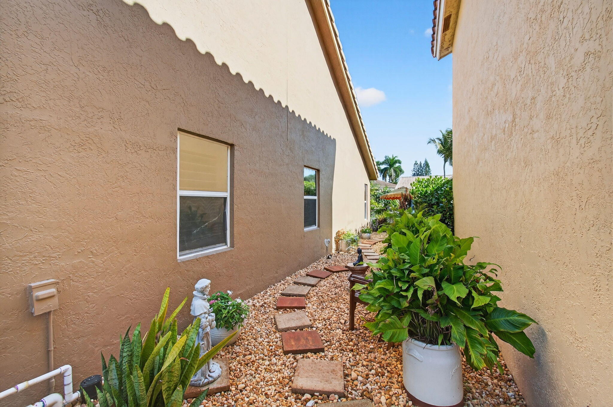 21400 Millbrook Court Boca Raton, FL 33498 - Photo 65 of 65 a potted plant sitting in front of a house