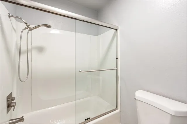 a bathroom with a glass shower door
