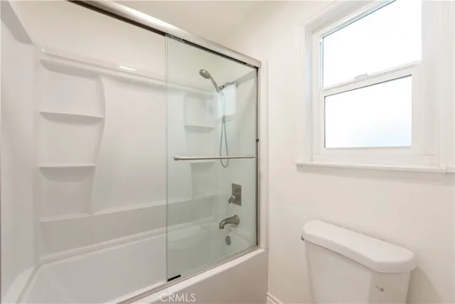 a bathroom with a shower and a toilet