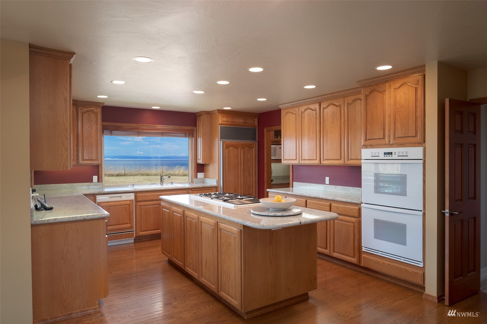 213 Mariners Point Road Sequim, WA 98382 - Photo 13 of 40 a kitchen with stainless steel appliances kitchen island granite countertop a sink stove and refrigerator